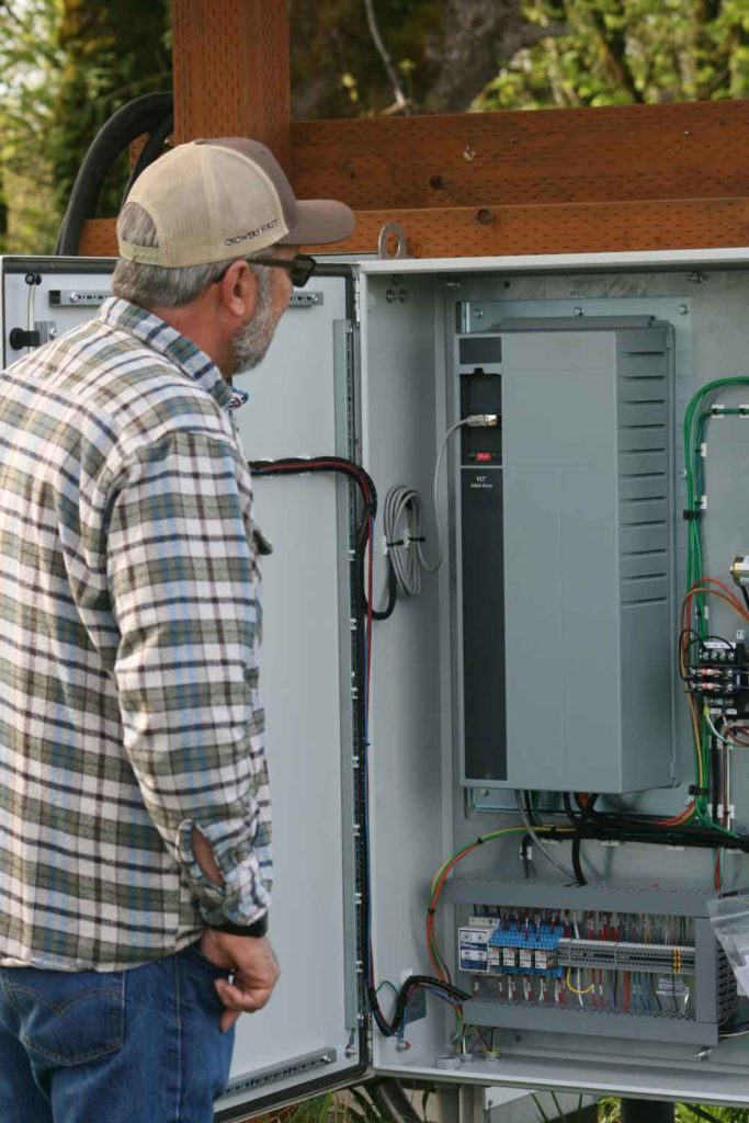 Jeff Newton checks a Variable Frequency Drive, or VFD. It controls pump output.